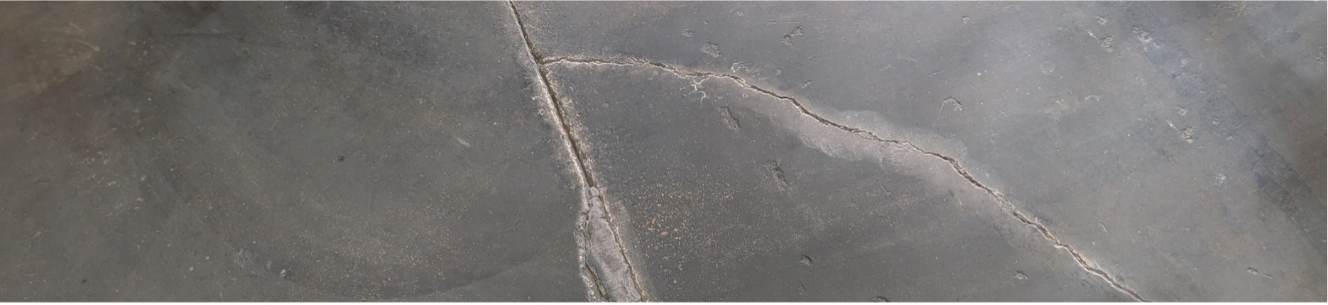 FasTrac Crackweld Pro Header Image Photo of a cracked concrete warehouse floor in need of repair with FasTrac Crackweld Pro.